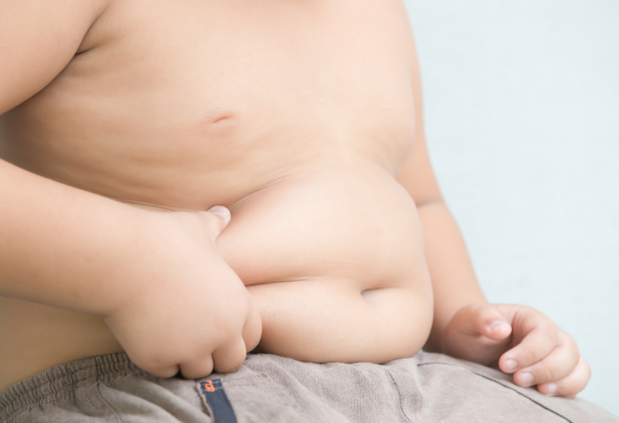 Kid Pinching Excess Skin on Abdomen