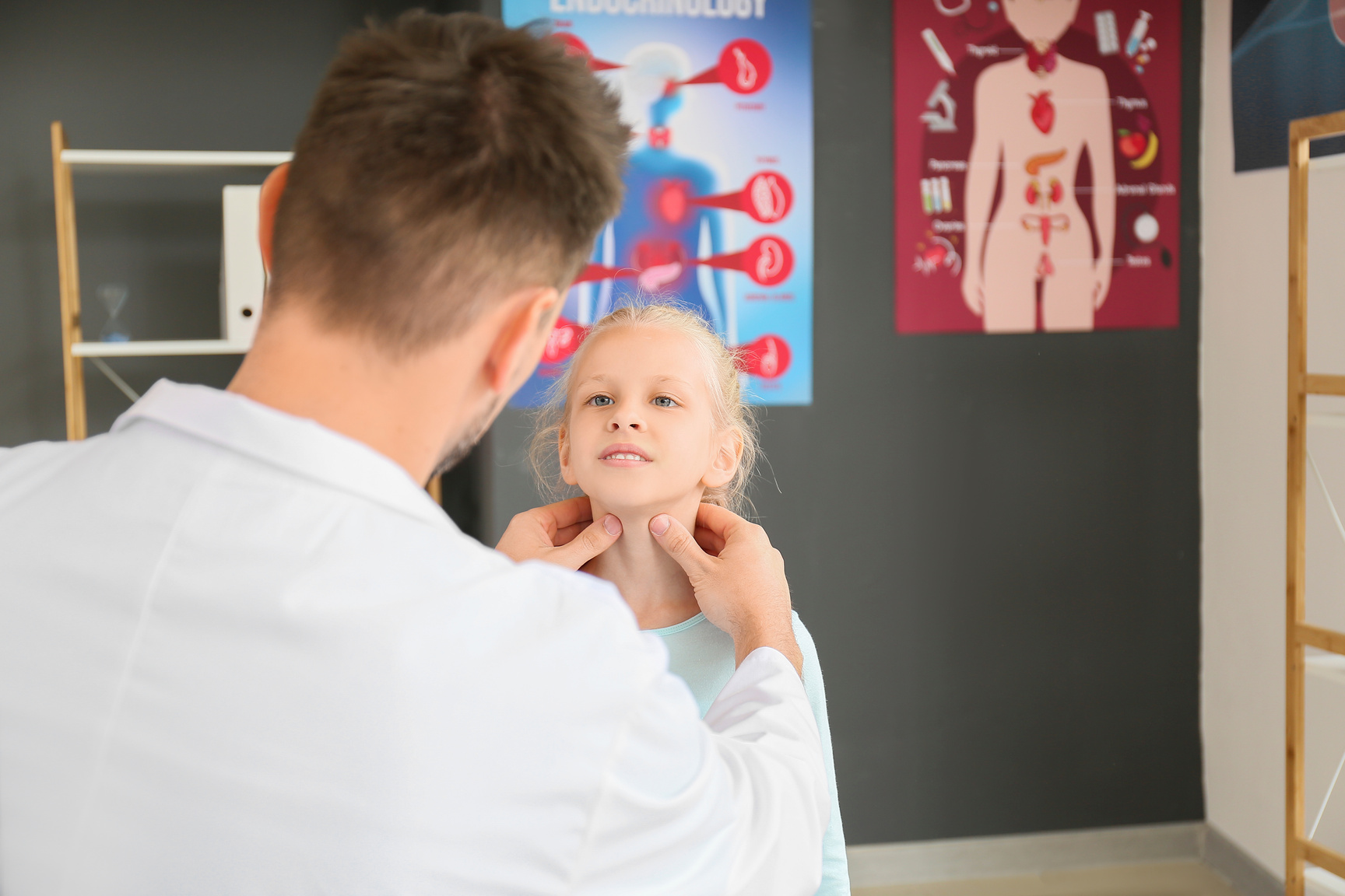 Doctor Examining Little Girl with Thyroid Gland Problem